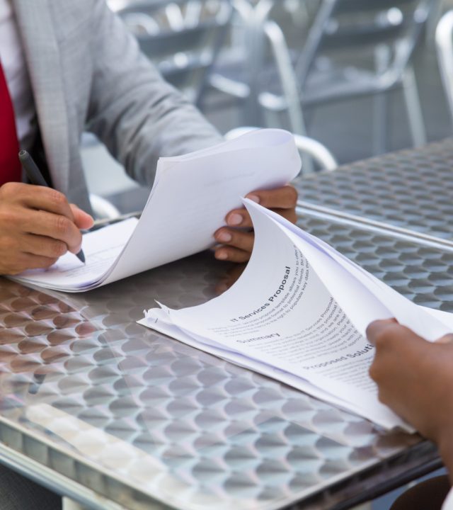 business-partners-checking-signing-document